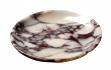 Round cream and dark veined stone dish with a curved rim, three-quarter view