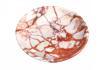 Round red and white veined stone dish, viewed from above