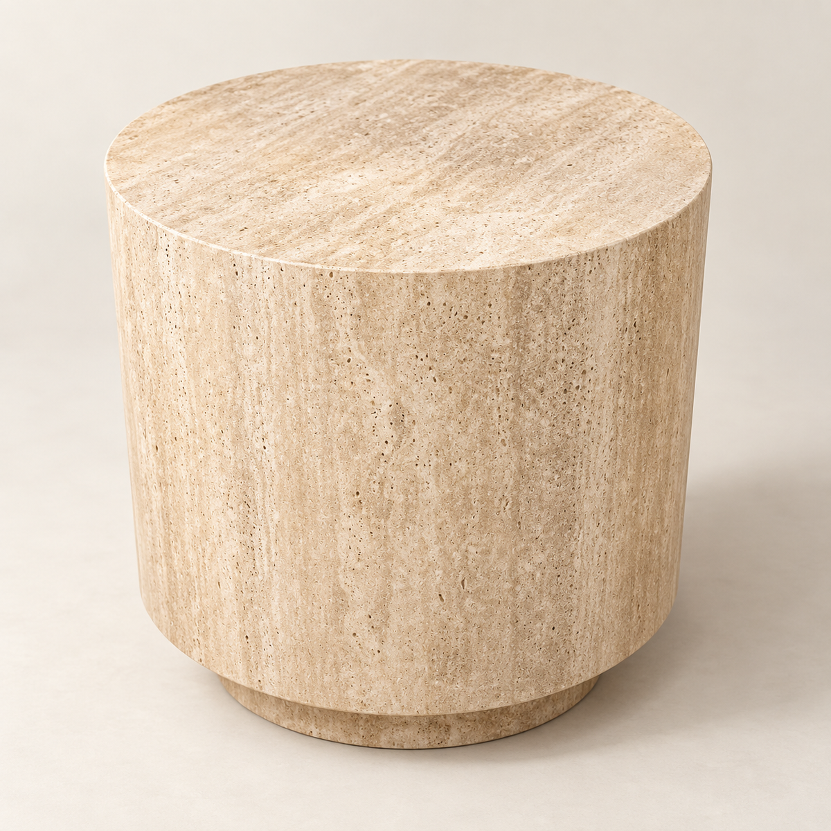 Smooth drum side table in beige travertine