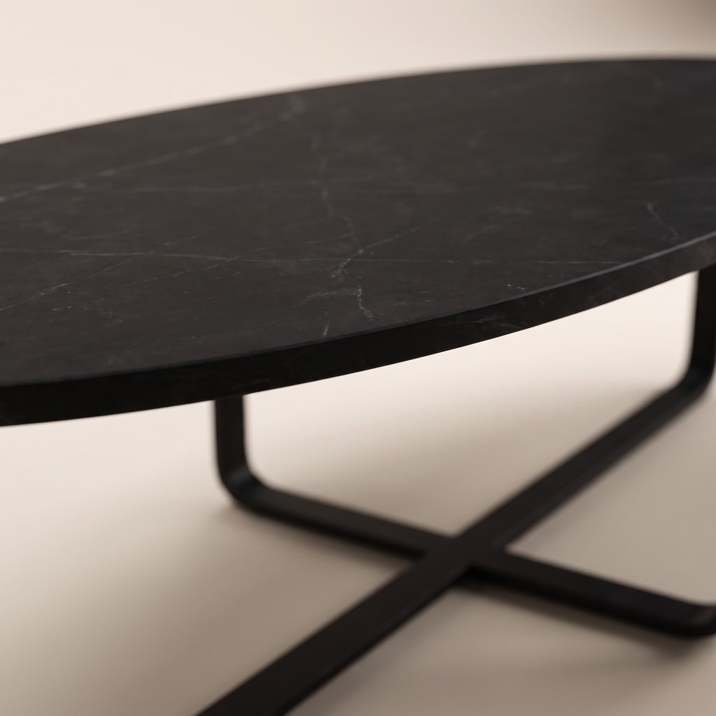 Oval Black Marble Coffee Table — Metal Cross Base, edge detail