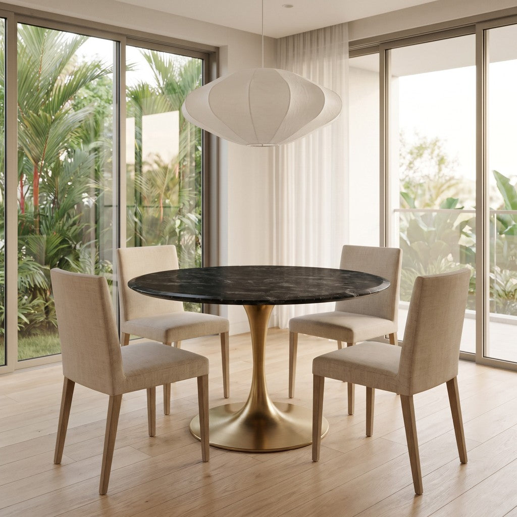 Round Black Marble Dining Table — Brass Tulip Base, in a dining room