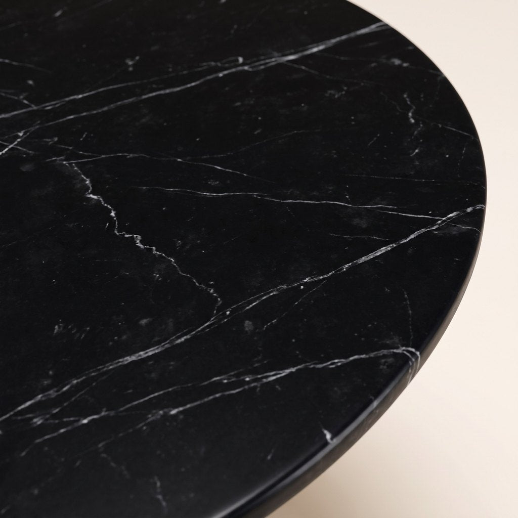Round Black Marble Dining Table — Cone Pedestal: close-up of the black marble surface