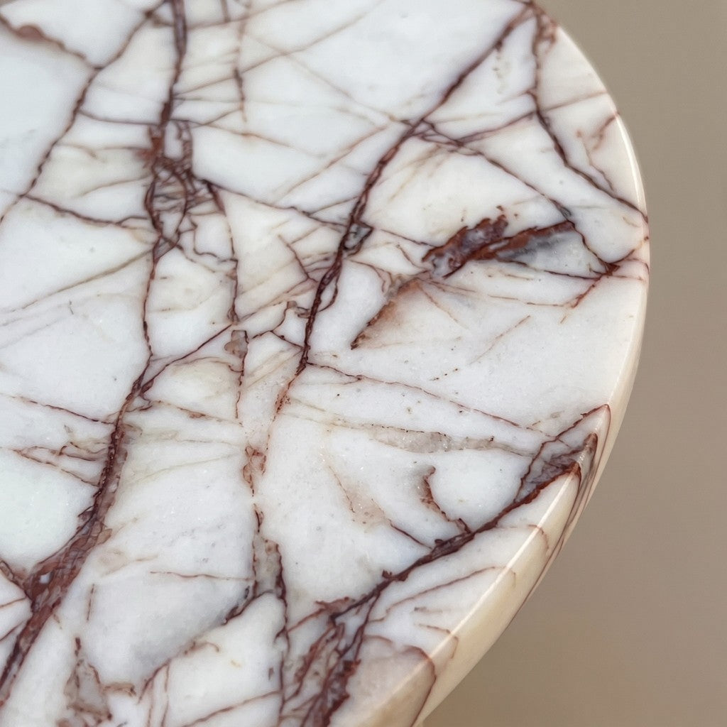 Round White Veined Stone Side Table — Cross Base: close-up of the stone surface